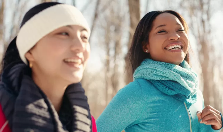 2 women walking outside in winter