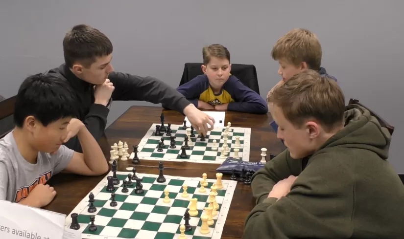 5 kids playing chess