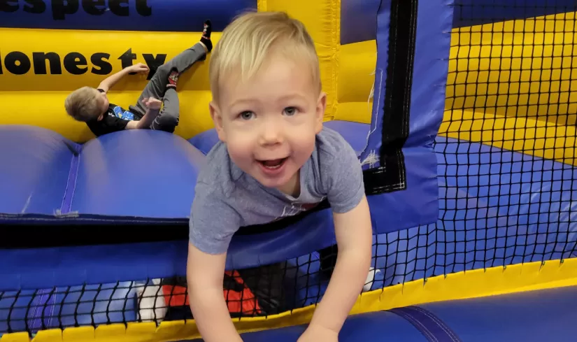 child playing in bounce house