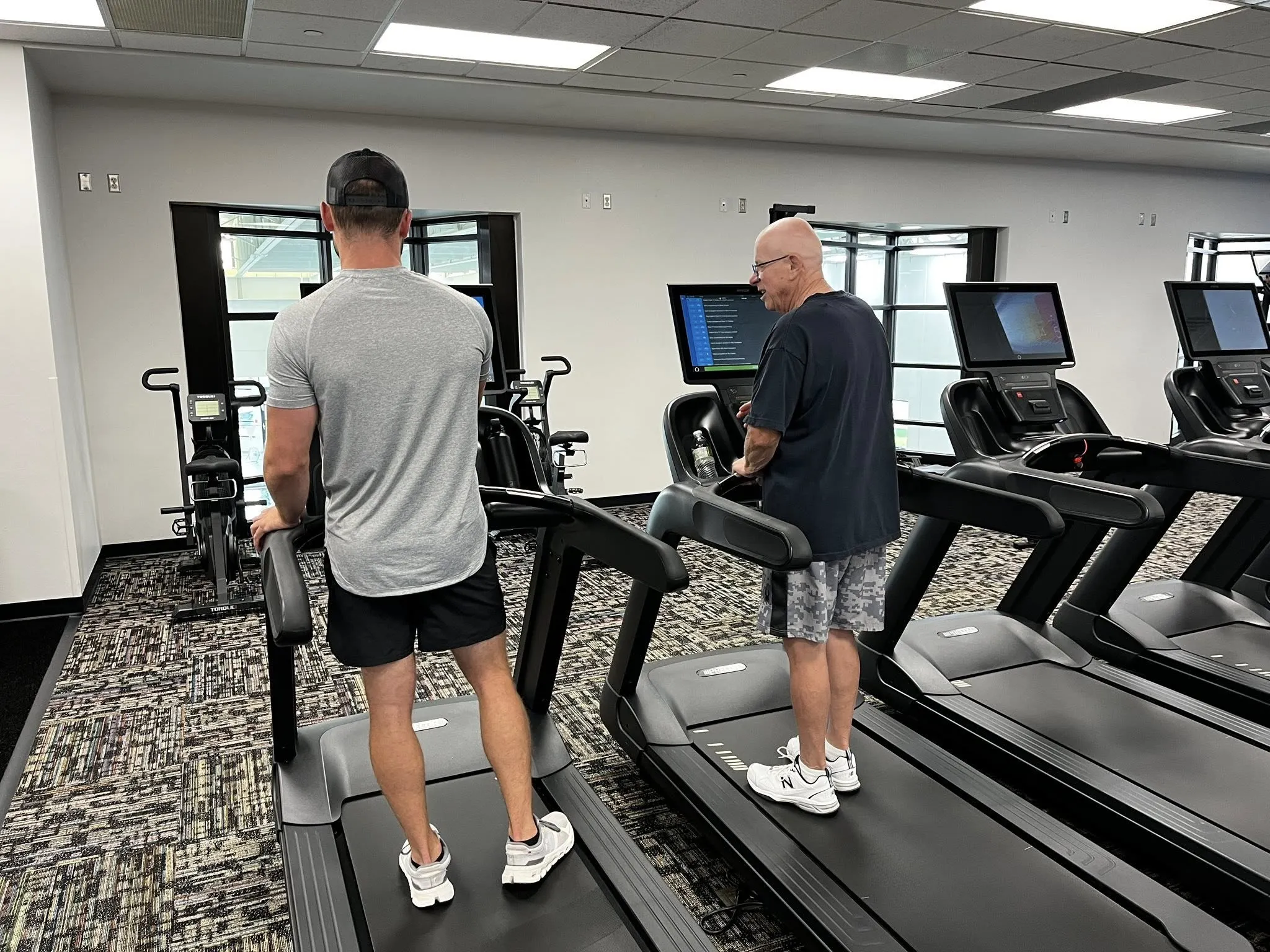 YMCA trainer showing a member how to use the treadmill