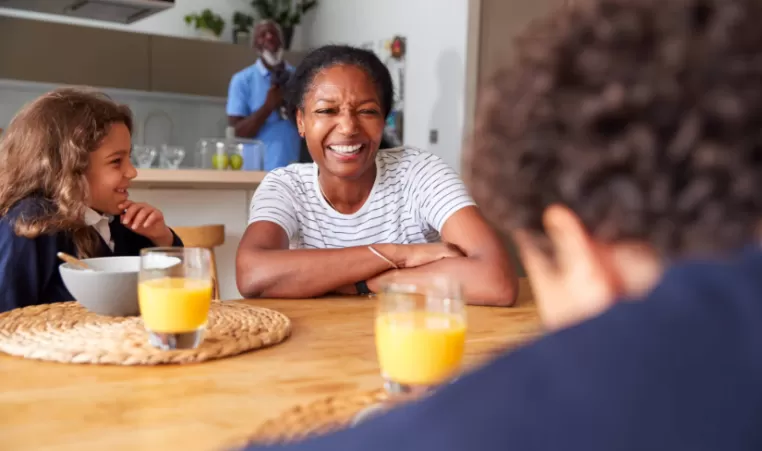 woman and tow children at the breakfast table