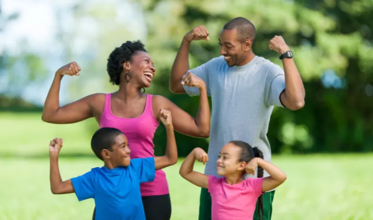 Family of four flexing their muscles