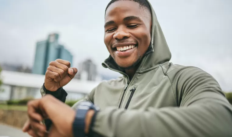 excited man looking at smart watch