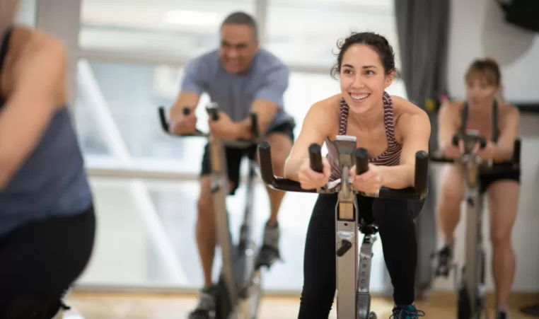 smiling woman in a cycling class