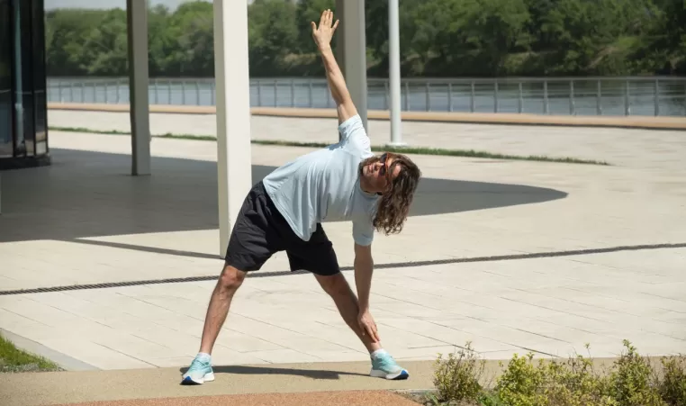 man doing a fitness warmup outdoors