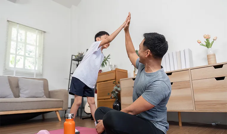 dad and child giving high five after a workout