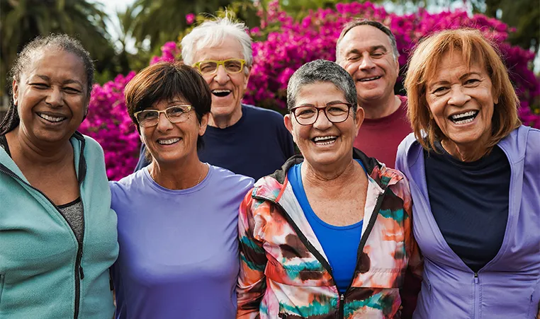 group of senior friends smiling on camera