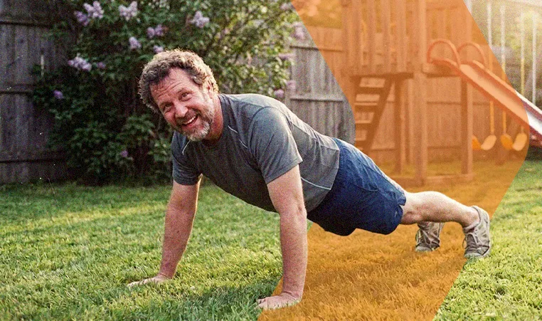 man doing push-ups in his backyard on a sunny day