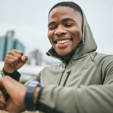 excited man looking at smart watch