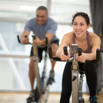 smiling woman in a cycling class