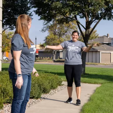 two volunteers working on landscaping at the YMCA