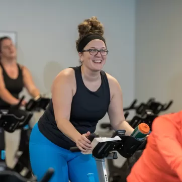 smiling woman in a cycling class