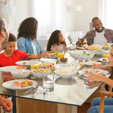 two families enjoying dinner around a dining room table