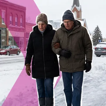 senior man and woman walking on an icy sidewalk