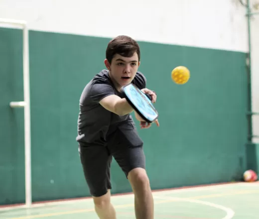 boy playing pickleball